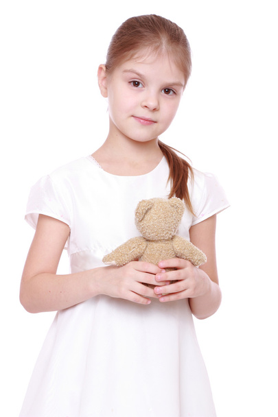 Adorable toddler girl hugging a teddy bear - Zdjęcie, obraz