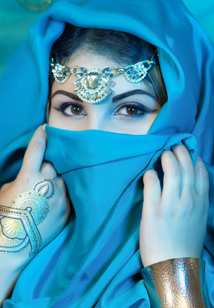 Portrait of eastern woman closeup with blue scarf. Arabian woman. - Фото, изображение