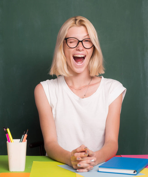 Happy funny teacher winking. Portrait of young caucasian female teacher or student. Cheerful teacher on lesson. Teaching. - Foto, Bild