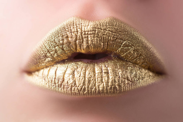 Sexy lips. Closeup sexy beautiful female golden lips isolated. Gold lipstick. - Foto, Imagen