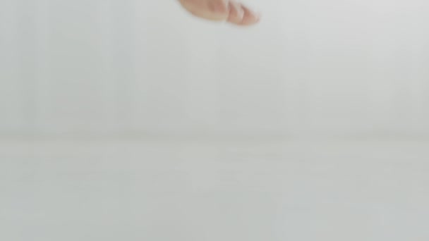 Feet care concept. Close up shot of unrecognizable barefoot woman stepping on floor and going away, empty space - Footage, Video
