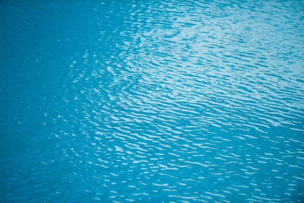 Abstract ripple wave and clear turquoise water surface in swimming pool, blue water wave for background and abstract design. - Foto, Imagem