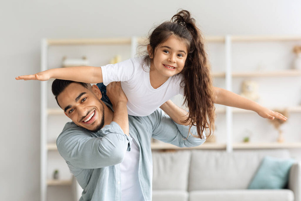 Happy arab father and daughter having fun together at home - Фото, изображение