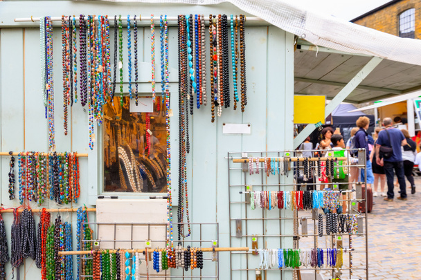 Assorted beaded necklaces and bracelets on display at Camden Market in London - Photo, Image
