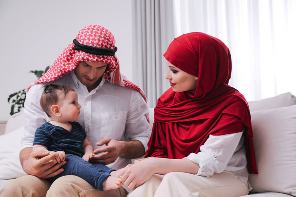 Happy Muslim family with little son in living room - Photo, image