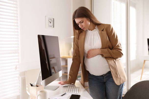 Tired pregnant woman working at home. Maternity leave - Фото, изображение