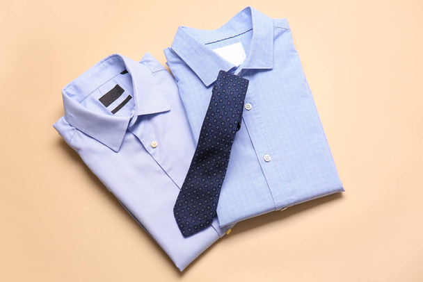Stylish male shirts with tie on color background - Photo, Image