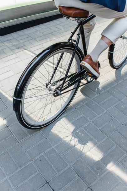 cropped view of man riding bicycle outside - Photo, image
