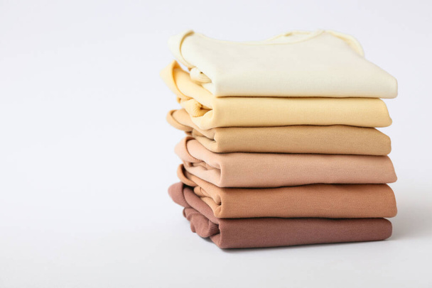 Stack of baby clothes on grey background - Photo, Image