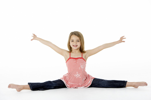 Young Girl In Gymnastic Pose Doing Splits - 写真・画像