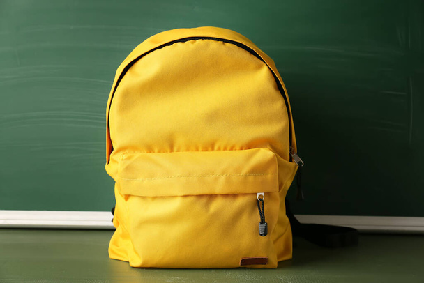 School backpack with stationery on color background - Photo, Image