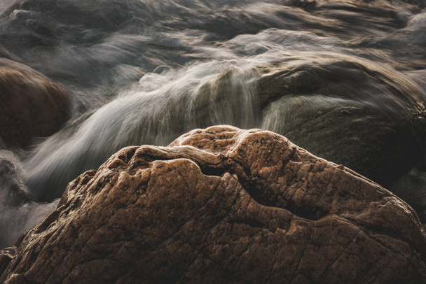 A closeup shot of a rocky shore for wallpaper and background - Foto, Imagem