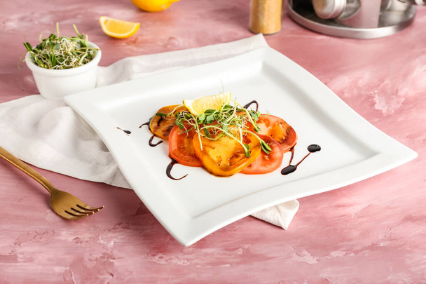 Plate with tasty tomato carpaccio and fresh sprouts on color background - Photo, Image