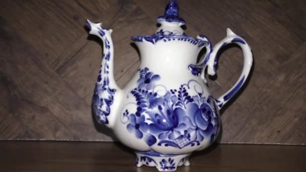 Teapot in Russian traditional Gzhel style. Gzhel - Russian folk craft of ceramics and production porcelain and a kind of Russian folk painting. Home tableware. Closeup.  - Footage, Video