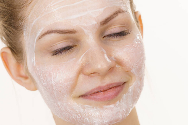 Young woman with cream cosmetic, mask moisture on her face. Beauty treatment. Skincare. - Foto, Imagem