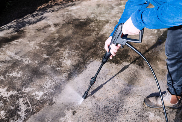 high pressure washer cleaning backyard or driveway concrete paving, concept of DIY and home improvement - Fotografie, Obrázek