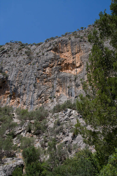 A rocky cliff against the blue sky - Photo, Image