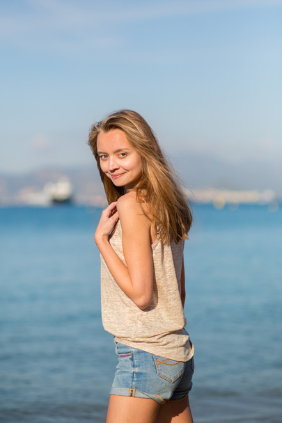 Young woman posing near the sea - Foto, immagini
