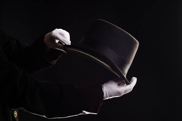 Hand gestures. Showman shows disappearing tricks in a hat, white gloves and black top hat, - Fotoğraf, Görsel