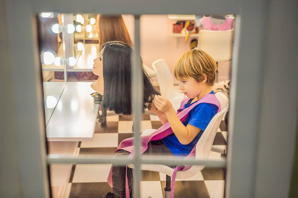 boy hairdresser, day of choice of profession, play at the hairdresser in the childrens beauty salon, hairstylist, hairdressing, barber job - Foto, Imagem