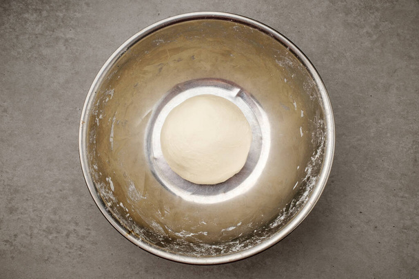 Round dough. Soft and moist dough. Dough mixed with flour and water - Fotó, kép