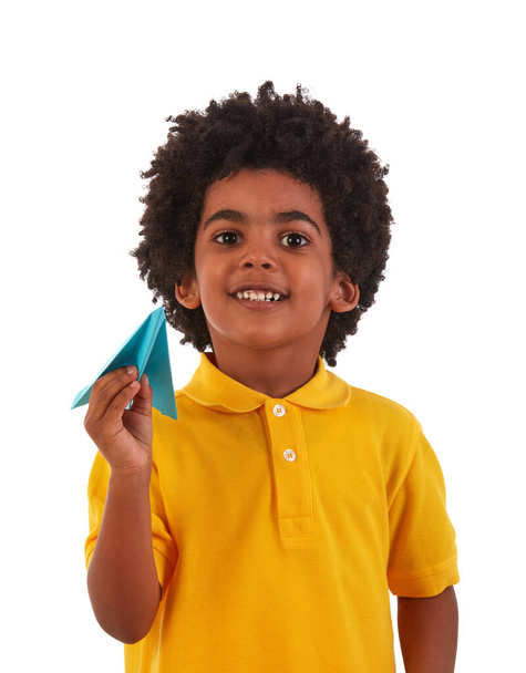 Cheerful young African boy with paper plane - Fotó, kép