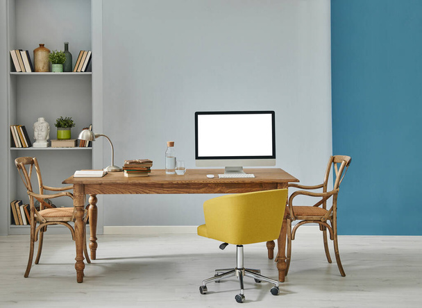 コンピュータとラップトップスタイル、レトロなキャビネットと棚の背景、青とグレーの壁のインテリアコンセプトを持つ装飾的な木製の家具オフィスルーム. - 写真・画像