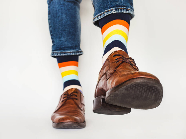 Men's legs, trendy shoes and bright socks. Close-up. Style, beauty and elegance concept - Fotó, kép