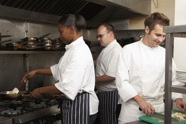 Team Of Chefs Preparing Food In Restaurant Kitchen - Foto, immagini