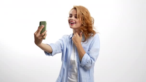 cheerful woman blow kiss on smartphone camera posing for photo, selfie - Footage, Video
