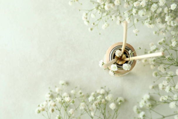 Diffuusori ja kukkia valkoinen kuvioitu pöytä - Valokuva, kuva