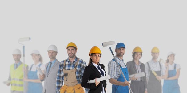 Group of industrial contractors workers people standing together on gray background, unity cooperation teamwork concept - Фото, изображение