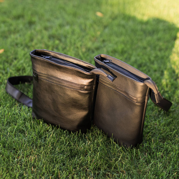 Two messenger bags in a grass - Foto, imagen