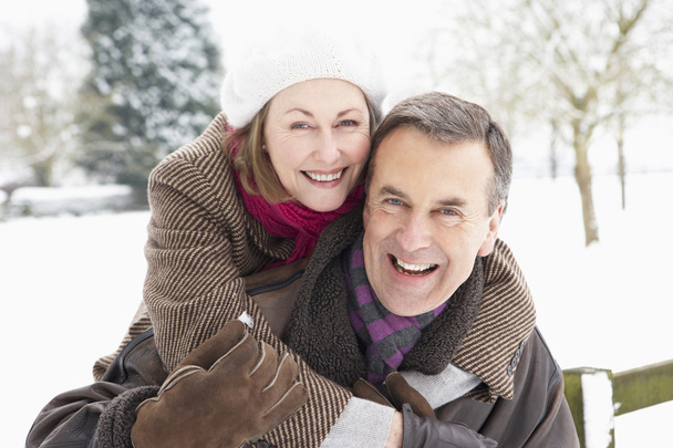 Senior Couple Standing Outside In Snowy Landscape - Photo, Image