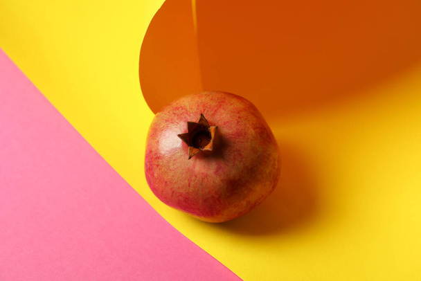 Ripe pomegranate fruit on two tone background - Valokuva, kuva
