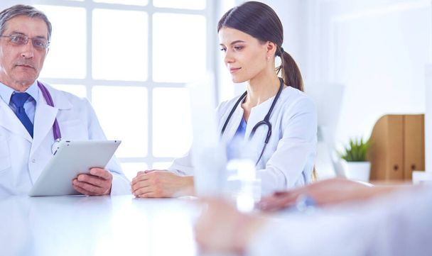 Doctors consulting with each other in a hospital conference room - Foto, immagini