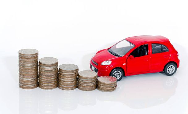 Red miniature car on coin stack : Car loan and leasing time concepts. Car insurance concepts. car model and financial with coins. - Fotó, kép