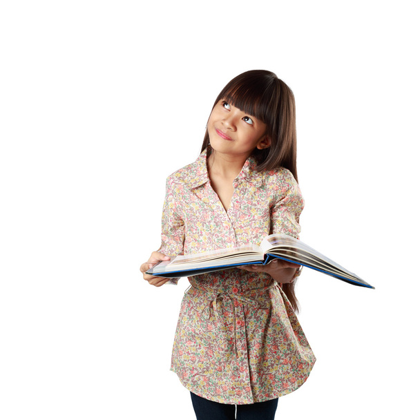 Little asian girl with textbook - Фото, изображение