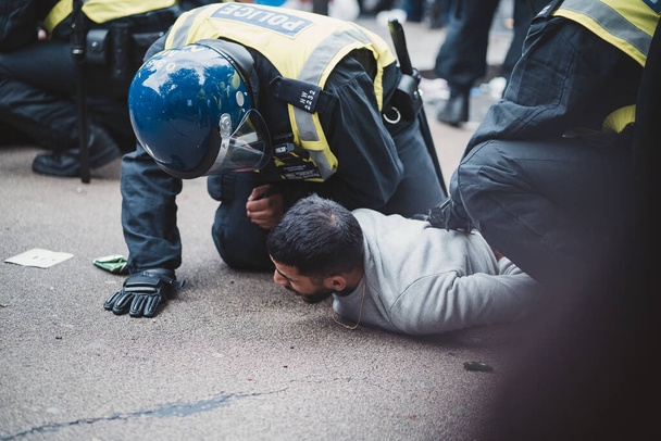London | UK - 2021.07.12: Police officers arresting two aggressive men at trafalgar square just before the Euro 2020 footbal match - 写真・画像