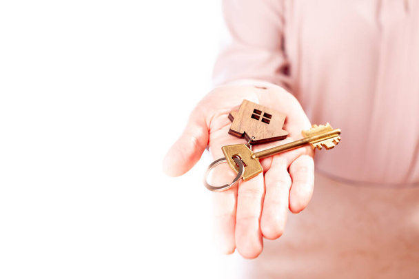 buying a house, hand with keys to the house, isolate on a white background - Фото, изображение