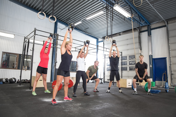 Team workout with kettlebells at fitness gym - Photo, Image