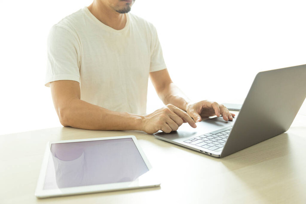 férfi használ laptop és tabletta fehér háttér - Fotó, kép
