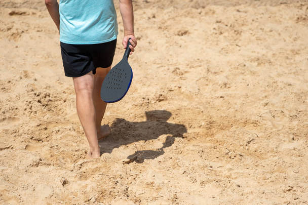 Man playing beach tennis on a beach. Professional sport concept - Foto, imagen