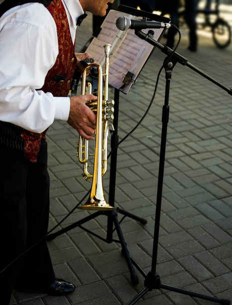older man playing trumpet. Jazz Musician with Flugelhorn on street background.  - Foto, Imagem