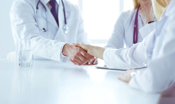 Doctor shaking hands with a male patient in the office - Foto, Imagem