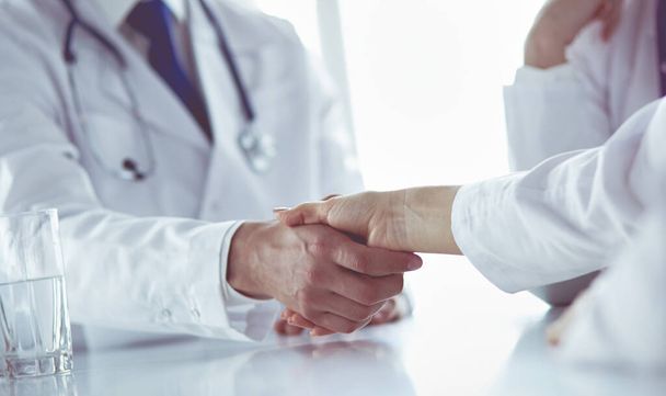 Doctor shaking hands with a male patient in the office - Φωτογραφία, εικόνα