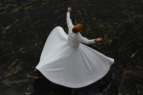 The image of whirling dervish on isolated or patterned background, Dervish is whirling for pray - Photo, Image