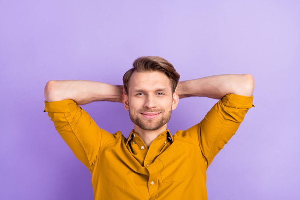 Photo of satisfied friendly man hands behind head smile look camera isolated on violet color background - Fotoğraf, Görsel