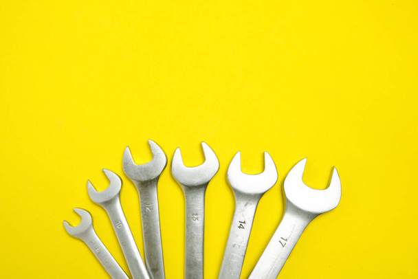 Set of wrenches on a yellow background - Фото, зображення