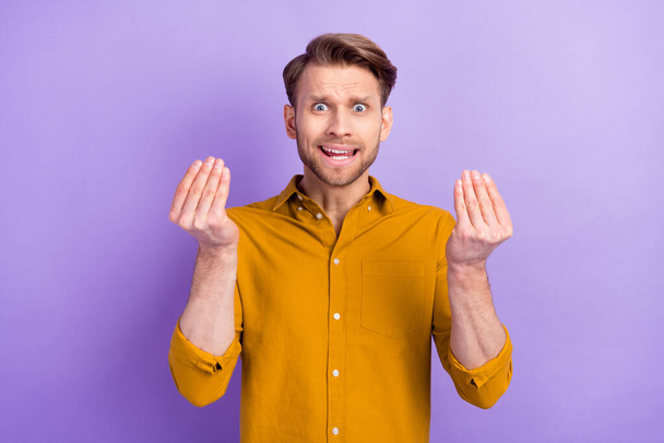 Portrait of unsatisfied person arms fingers show money symbol tell speak isolated on purple color background - Фото, изображение